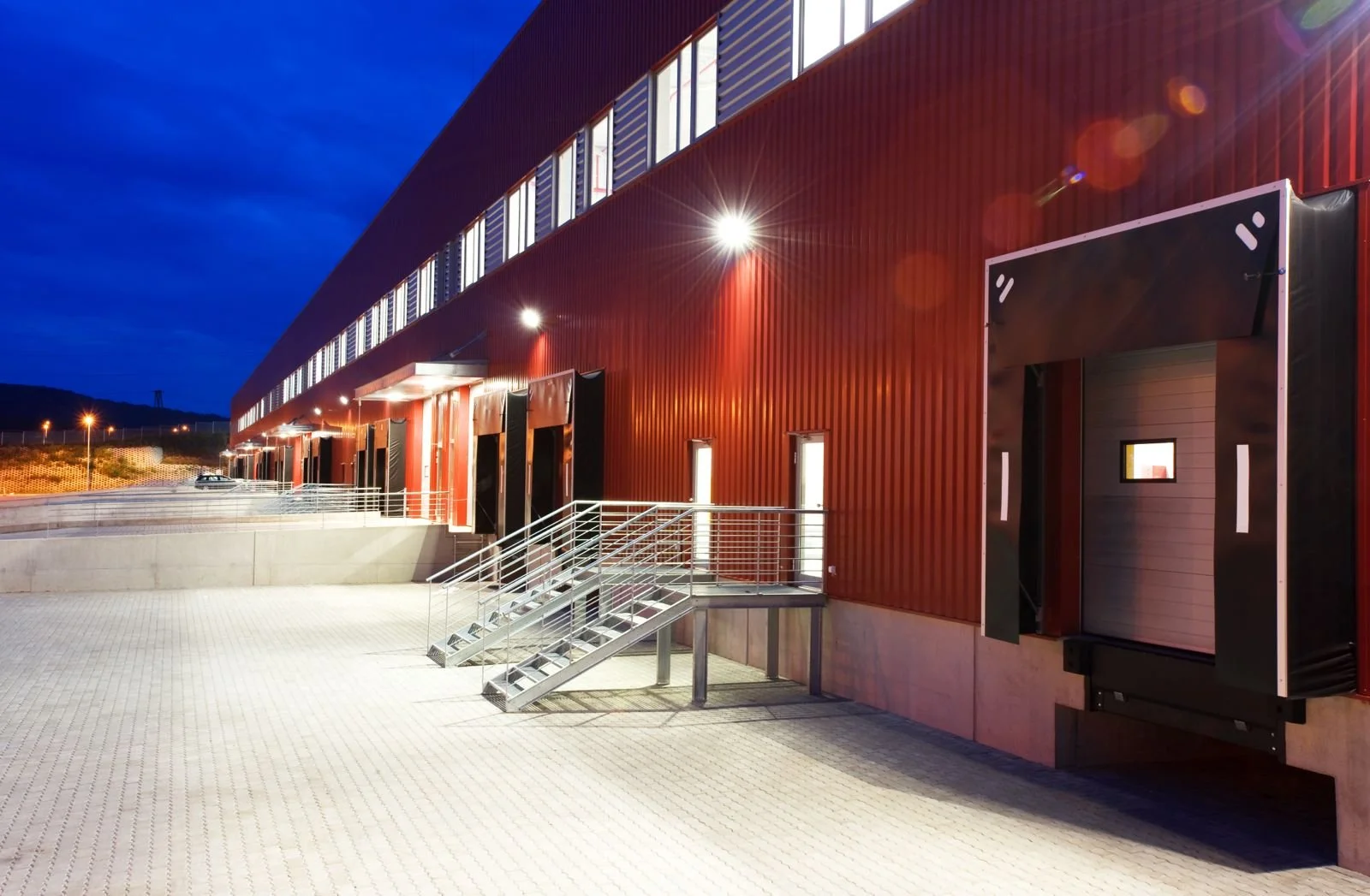 The entrance and facade of a modern building with evening lighting